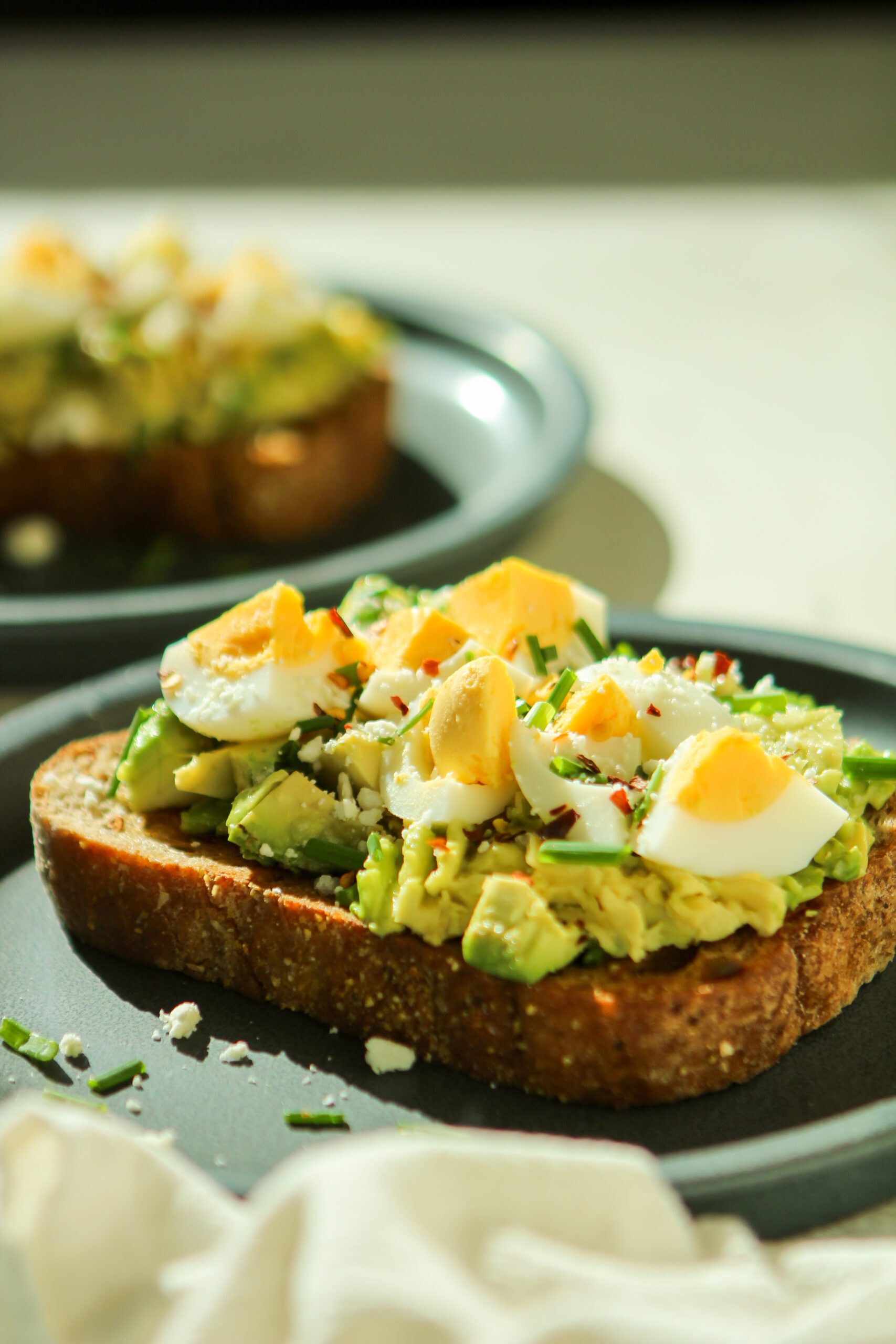 avocado toast with egg feta cheese and chives