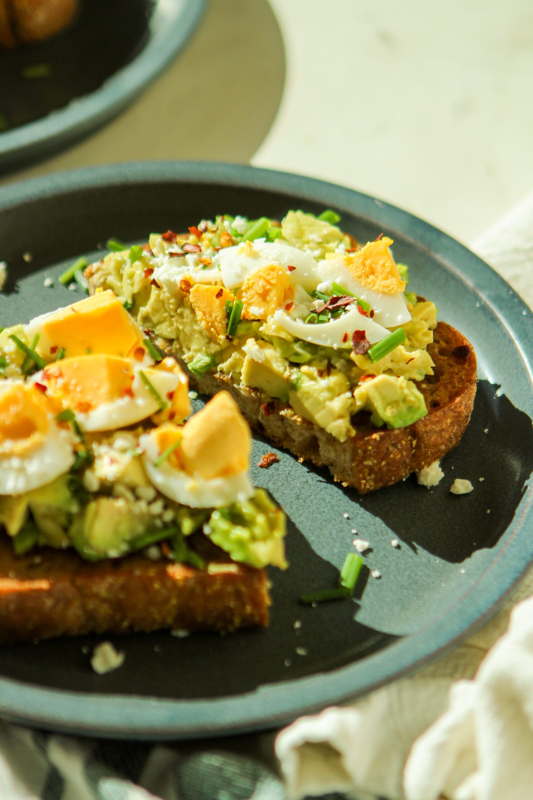 avocado toast with egg feta cheese and chives