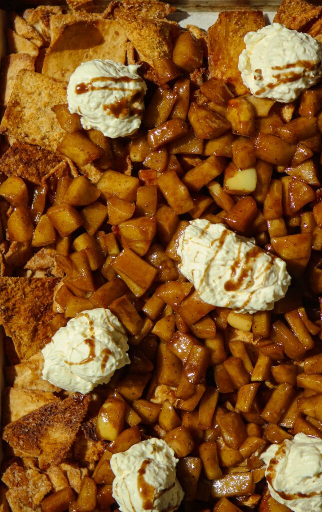 sheet pan cinnamon apple nachos topped with whipped cream cheese dip