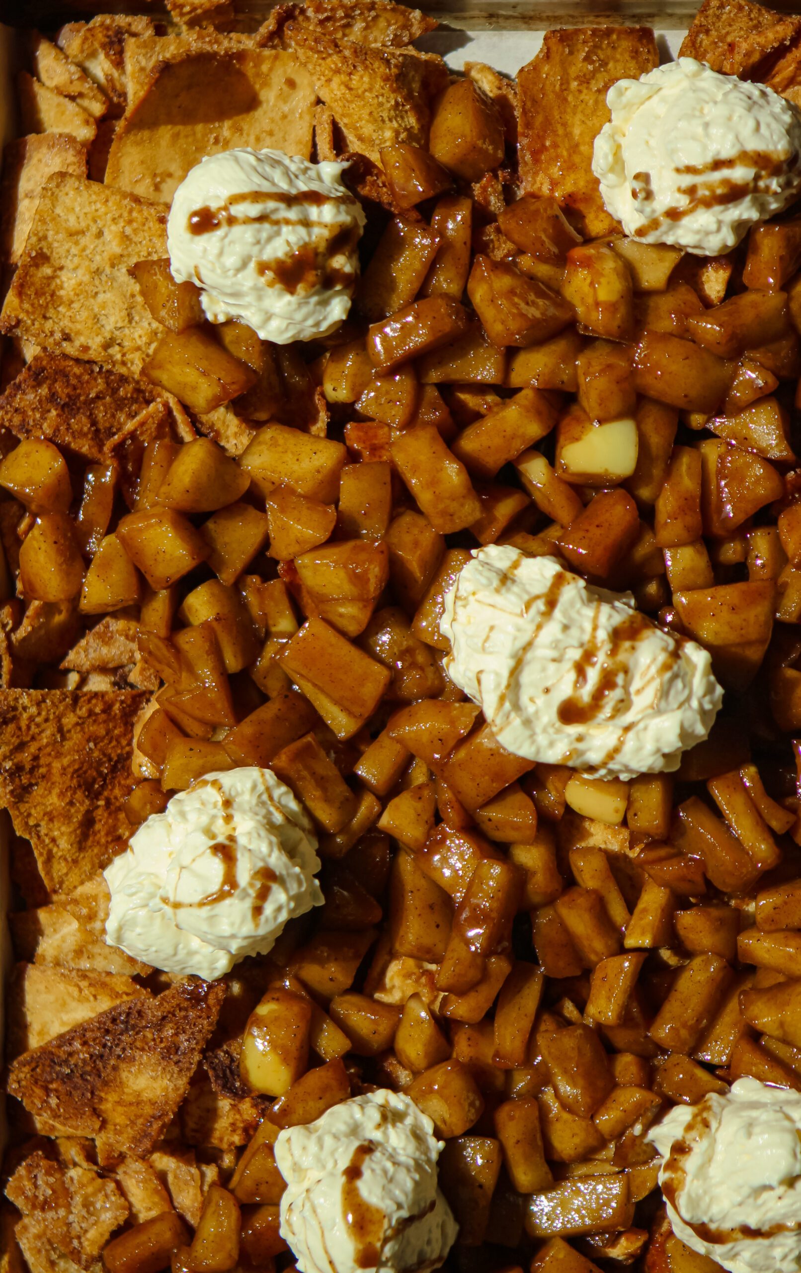 sheet pan cinnamon apple nachos topped with whipped cream cheese dip